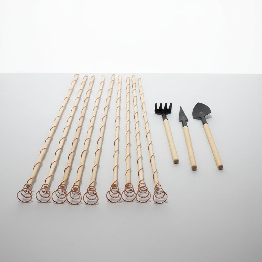 Set of wooden stakes with twisted design and gardening tools on a white sheet of paper.