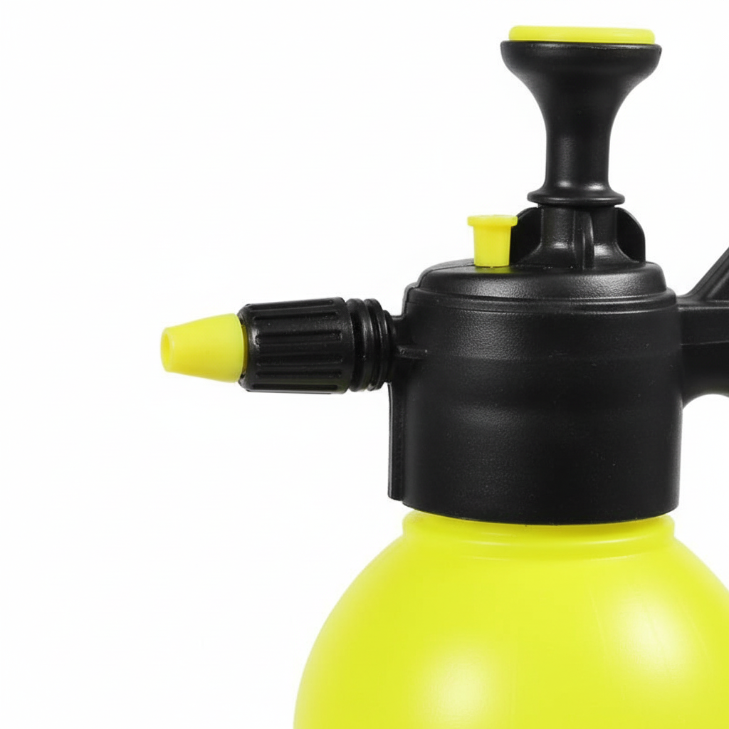 Yellow pressure sprayer with black nozzle on a white background