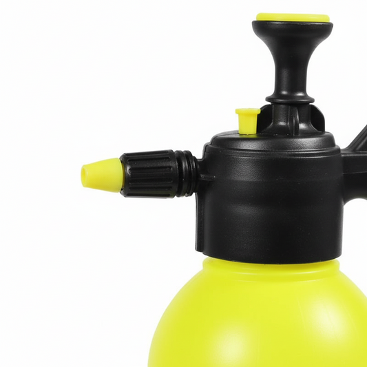 Yellow pressure sprayer with black nozzle on a white background