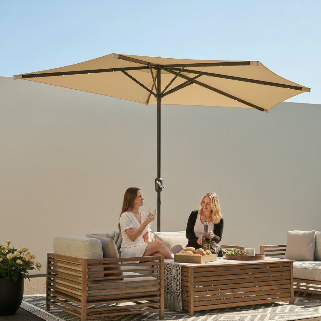 Two women sitting under a large outdoor umbrella in a modern patio setting.