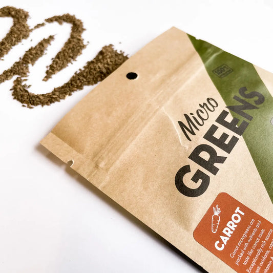 Kraft paper package of 'Micro Greens' with 'Carrot' label on a white background